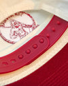 Close-up of a red and white snap back hat